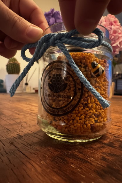 Tying blue rope on bee pollen jar